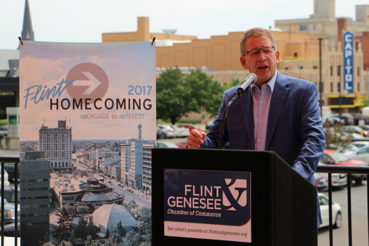 With the under-renovation Capitol Theatre in the background, Phil Hagerman talks about the importance of Flint Homecoming 2017 at a press conference Wednesday, June 28, 2017.