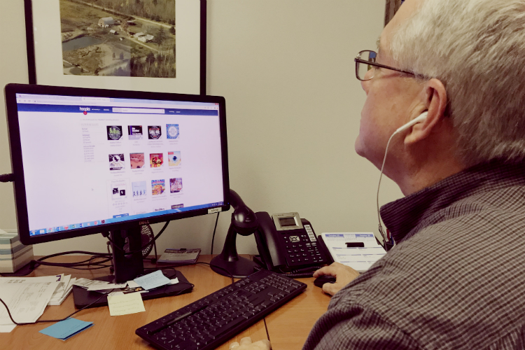 Darwin McGuire, Genesee District Library technical services manager, searches a wide selection of music on hoopla digital.