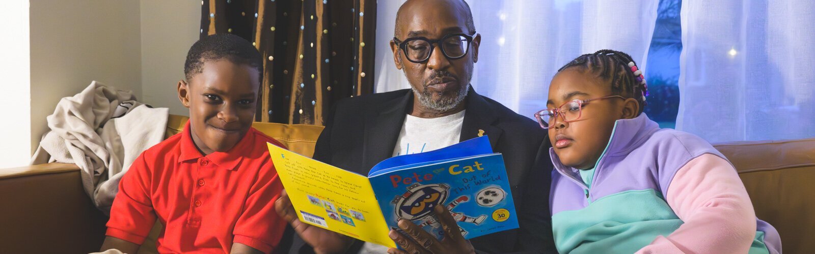 James Ribbron reads to Dwayne Sharpe and Elizabeth Brooks.