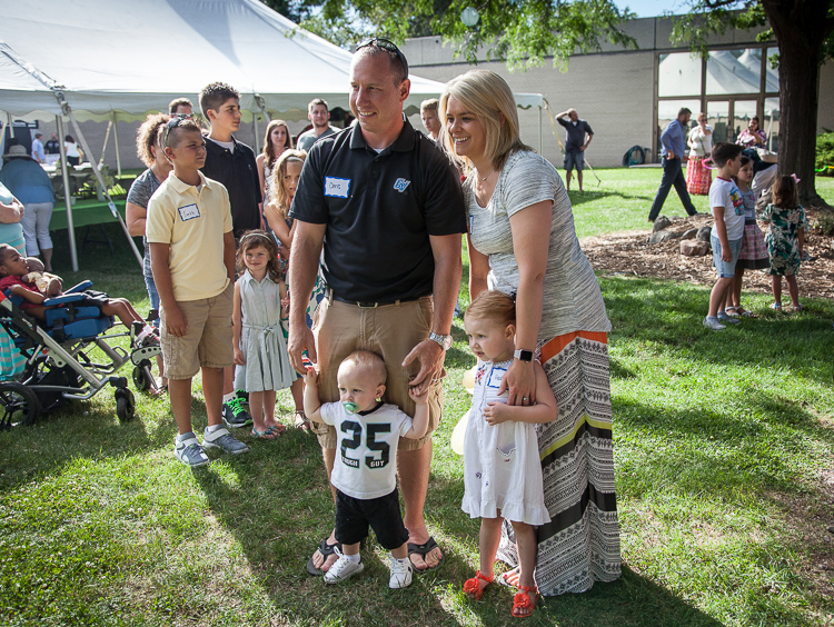 Chris (left) and Danielle Deines of Durand have their picture taken with their children Brodie and Hadlee at the 8th annual Miracle Picnic at the Sloan Museum on Tuesday. Hadlee was a leukemia patient at Hurley Children's Hospital.