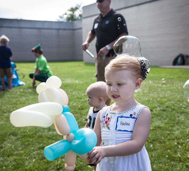  Hadlee Deines, 3, plays with a balloon sculpture at 8th annual Miracle Picnic for Hurley Children’s Hospital at the Sloan Museum on Tuesday. She underwent treatment for leukemia at Hurley.