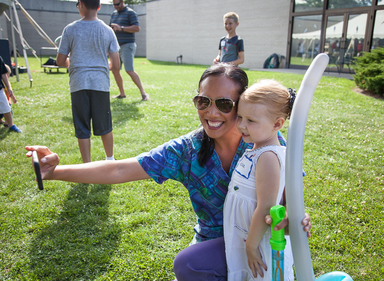 Hadlee Deines, 3, poses for a selfie with a Hurley nurse at the 8th Annual Miracle Picnic at the Sloan Museum on Tuesday. 