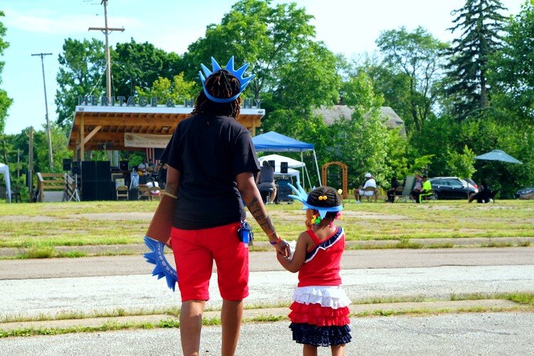 Attendees walk towards the stage wearing statue of liberty crowns on the Fourth of July, the last day of the Heritage and Harmony festival.