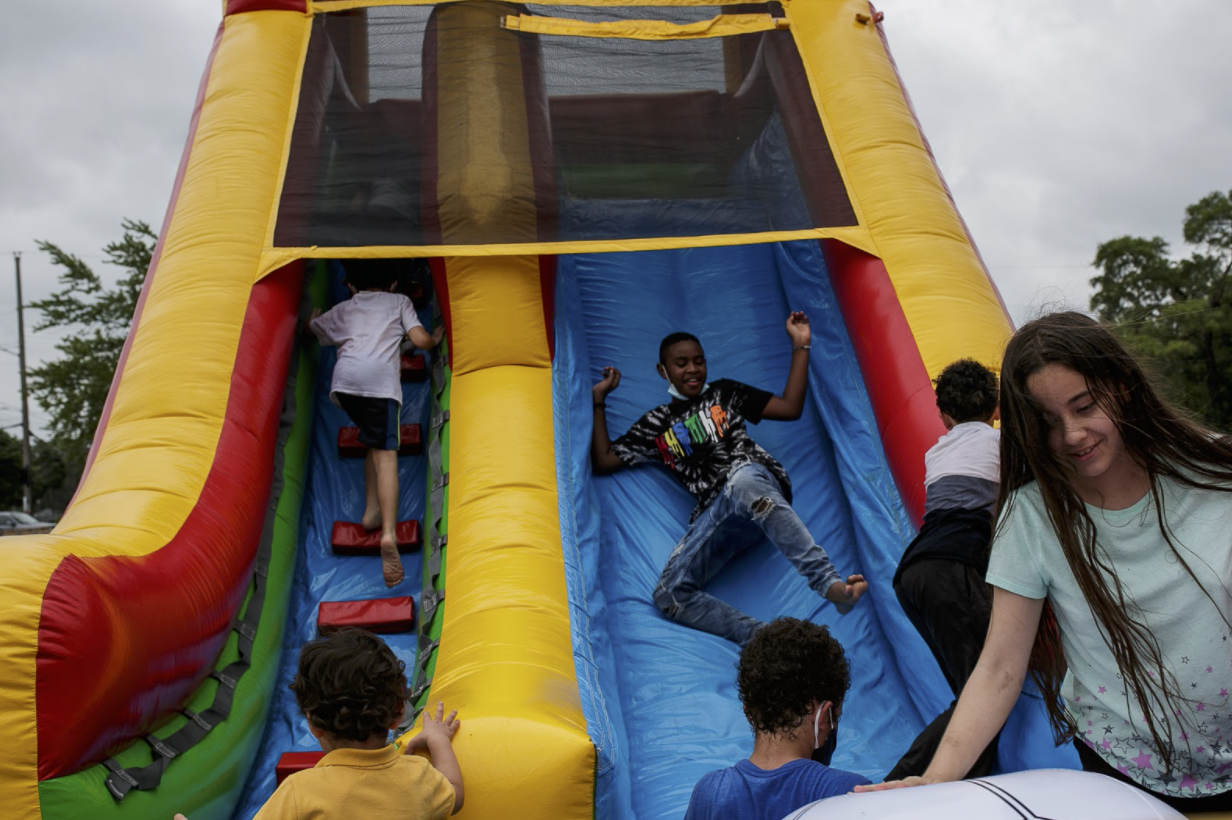 "I watched kids play in the jump house while their mothers warned them in Spanish to be careful, “Cuidado hija!”"