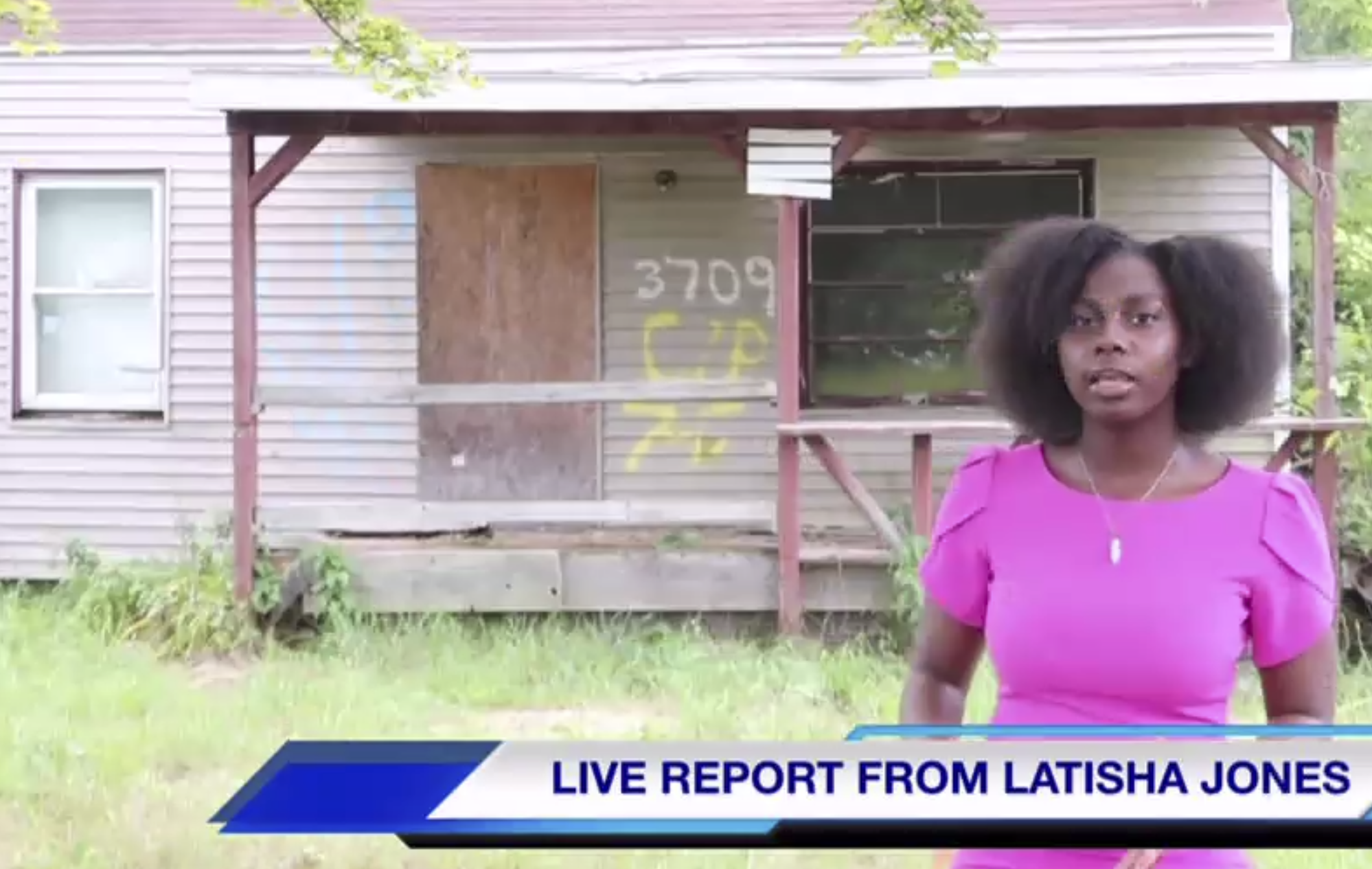 Flint native Latisha Jones standing in front of her childhood home.