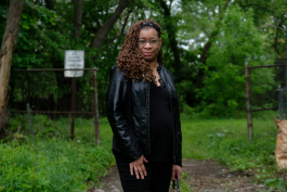 Linn Aikins stands at the entrance to Dougherty Park, which she has made her mission to cleanup.