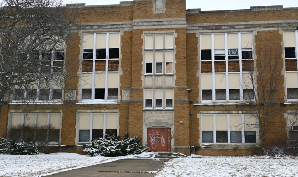 Various windows are boarded up or exposed with broken glass at Longfellow Middle School in Flint, Michigan on March 13, 2023.
