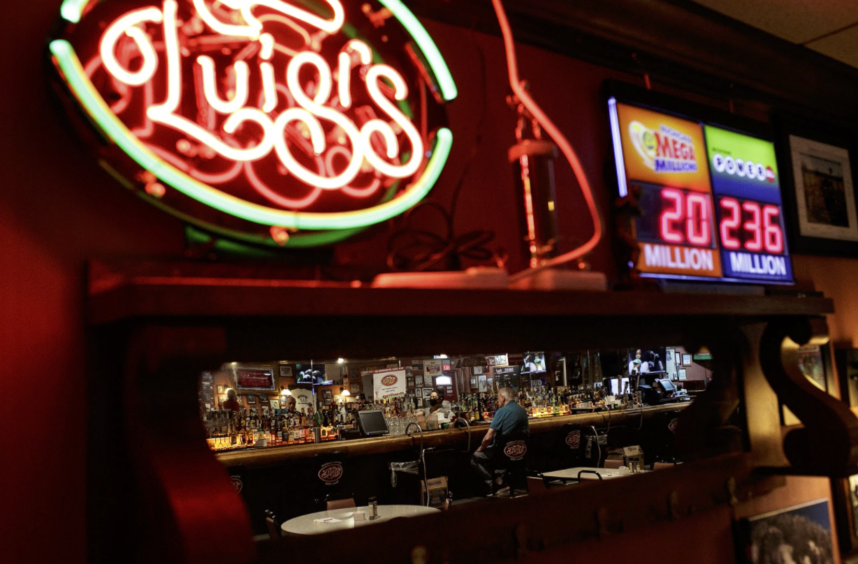 A customer waits at the bar inside Luigi's restaurant.