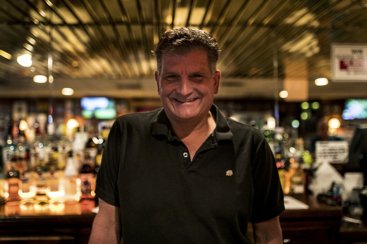 Tom Beaubien stands behind the bar inside Luigi's restaurant.