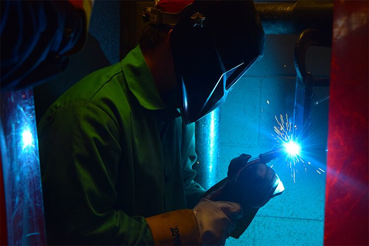 GCI welding student and Flushing High School senior, Luke Kenrick, practices his welding technique.