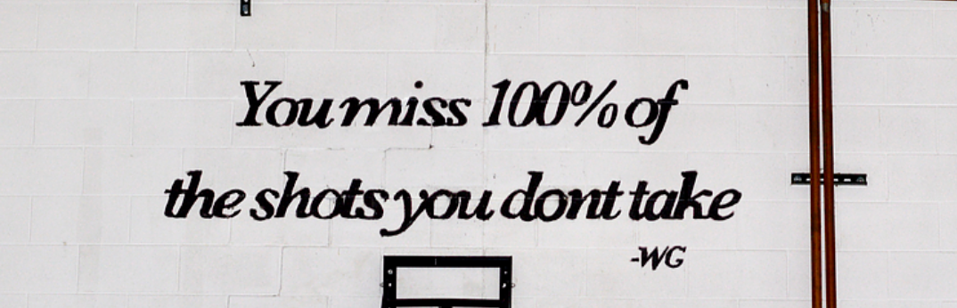 An inspirational quote is painted above a basketball hoop inside the St. Mark gym on Jan. 6, 2024.