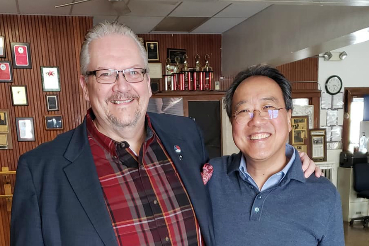 Mark Young poses for a photo with Yo-Yo Ma during his visit to Flint for a Day of Action on Feb. 28. 