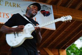 Maurice Davis gets lost in his guitar melody during his performance at the Heritage and Harmony festival. Davis is one of the festival organizers, "King of the Party Blues" and a Flint City Councilman.