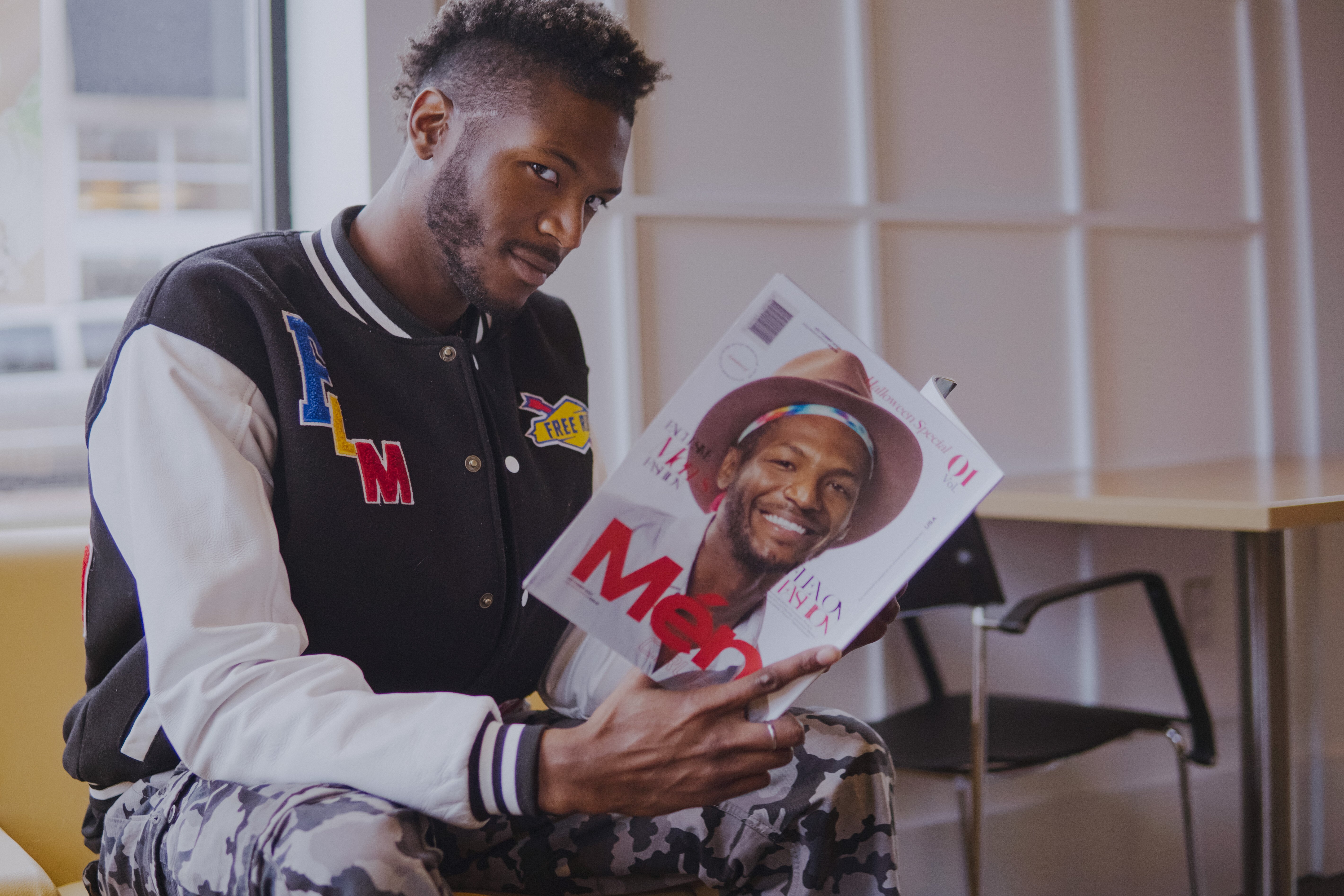 24-year-old music artist, model, social media influencer, and founder of Keeping Tabs Media and app Jonathan McKay, inside Mott Community College’s Coffee Beanery.