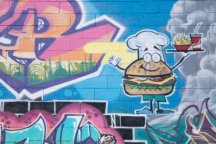 A burger, serving with a smile, at Capitol Coney Island Restaurant