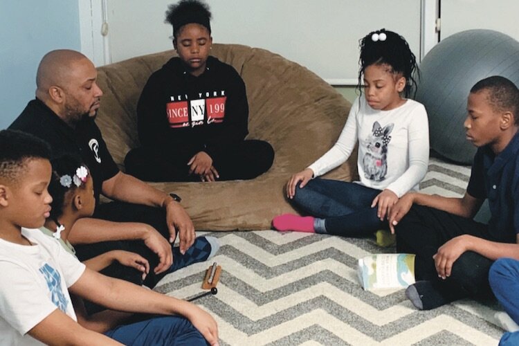 Principal Kevelin Jones at Doyle Ryder Elementary leading a mindful moment with his students in the Mindfulness room.