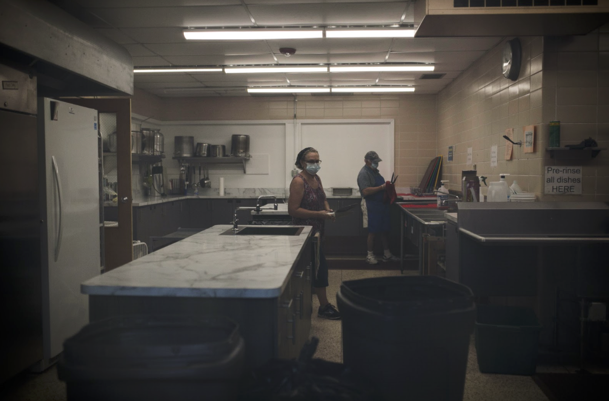 Volunteers from St Martin Lutheran Church clean the kitchen after the meal prep for Tuesday Diner in the kitchen at Franklin Avenue Mission.