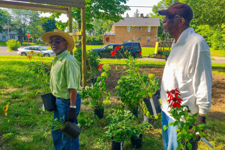 Matthew McEwan (left) and Charles Tutt were among the first volunteers to arrive for the full day of planting at the Martin Luther King Avenue Peace Garden.