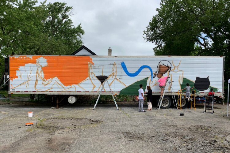 Mural painting began Friday at 11 a.m. and hour later the mural was already taking shape.