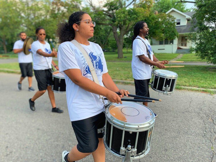 Kayla Wilson, 28, marches in the Civic Park Art Parade with her snare in in the Nightfire Drumline team. This is their sixth year providing percussion for the Flint Public Art Project Neighborhood Art Parades.
