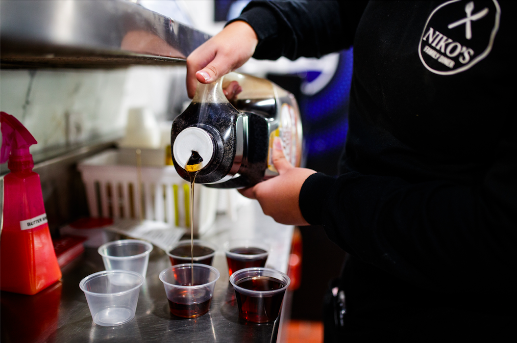 Destiny Wicks prepares maple syrup for distribution to customers at Niko’s Family Diner on November 22, 2023. 