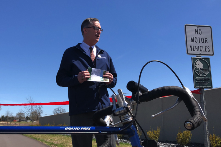 Barry June, director of Genesee County Parks, speaks before the official opening of the new section of trail connecting the Genesee Valley Trail and the Flint River Trail.