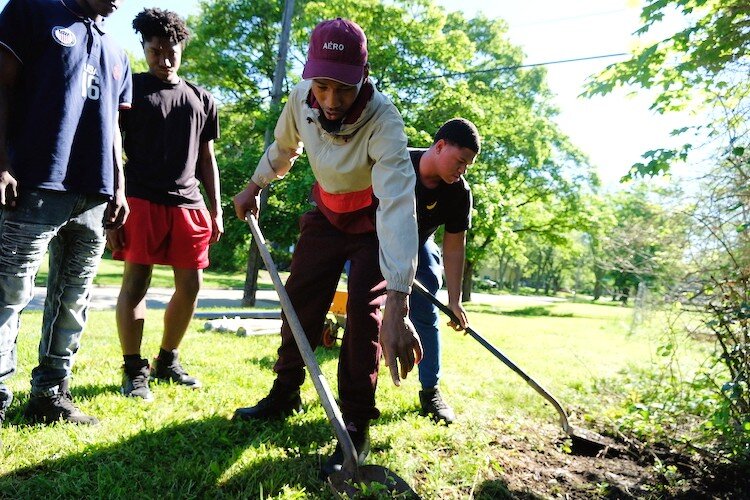 Nikita Johnson instructs the youth workers on brush removal at the agriculture house. He's served four years as a training supervisor with Clean and Green program.