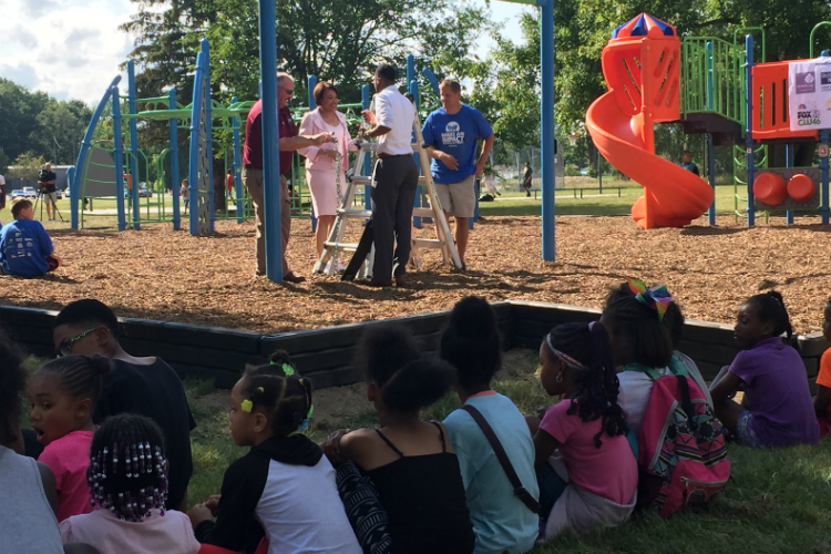 Key organizers talk just prior to the official opening of the new playground at Hasselbring Senior Center in Flint. 