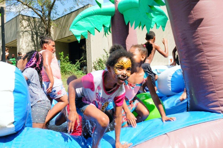 Kids play in front of Haskell Community Center at the 2nd Flint Town "Back to School" Carnival Splash, Saturday August 17.