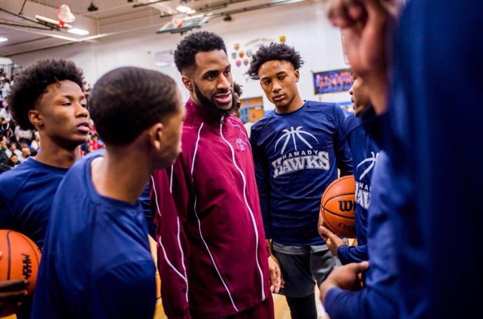 Flint native Roy “Rackk” Jackson Jr. gives a pep talk to the team during a Hamady High School basketball game. 
