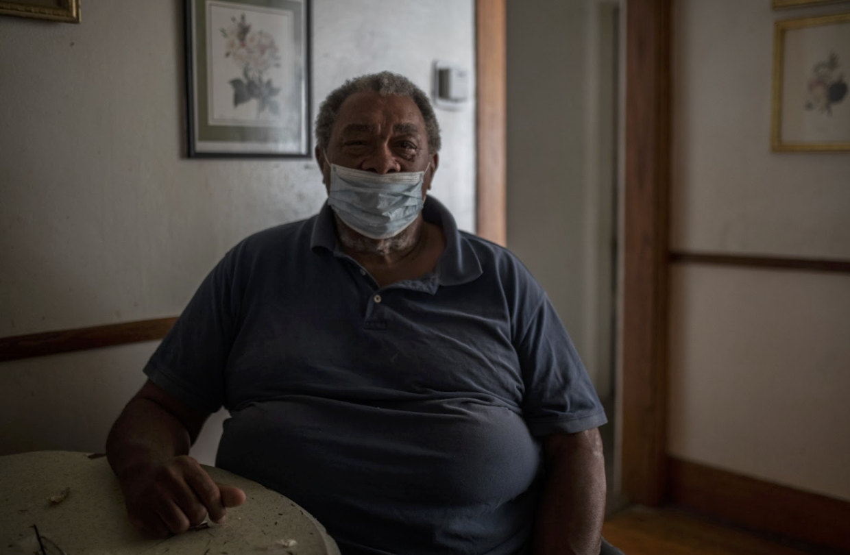 James Riley sits at his dining room table inside his home in Flint, Michigan.