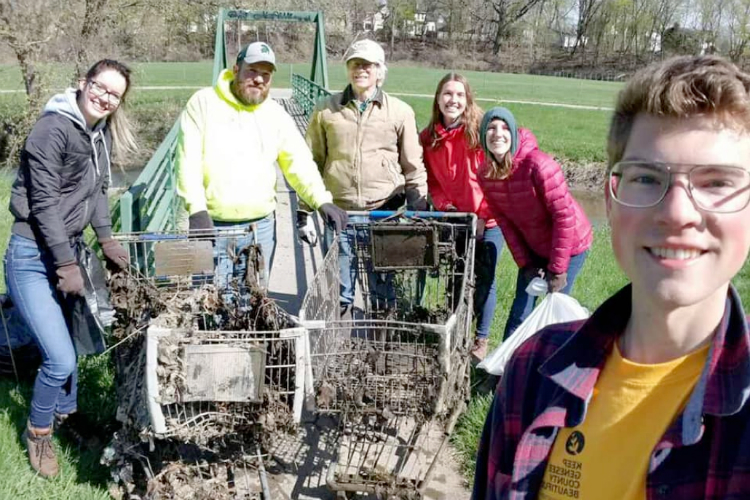 Volunteers stand with the shopping cards they pulled out of Gilkey Creek at Kearsley Park. 