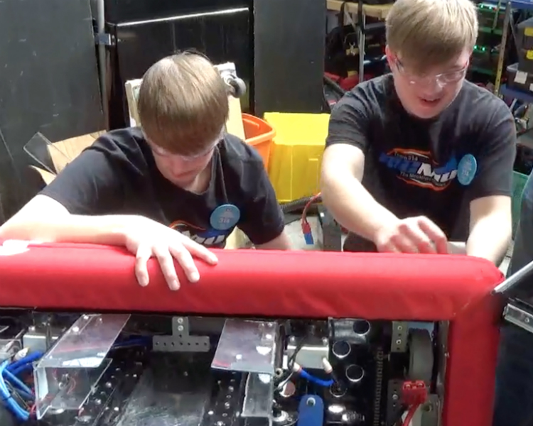 Ian Wickham works with a teammate prepare for FIRST Robotics competition.