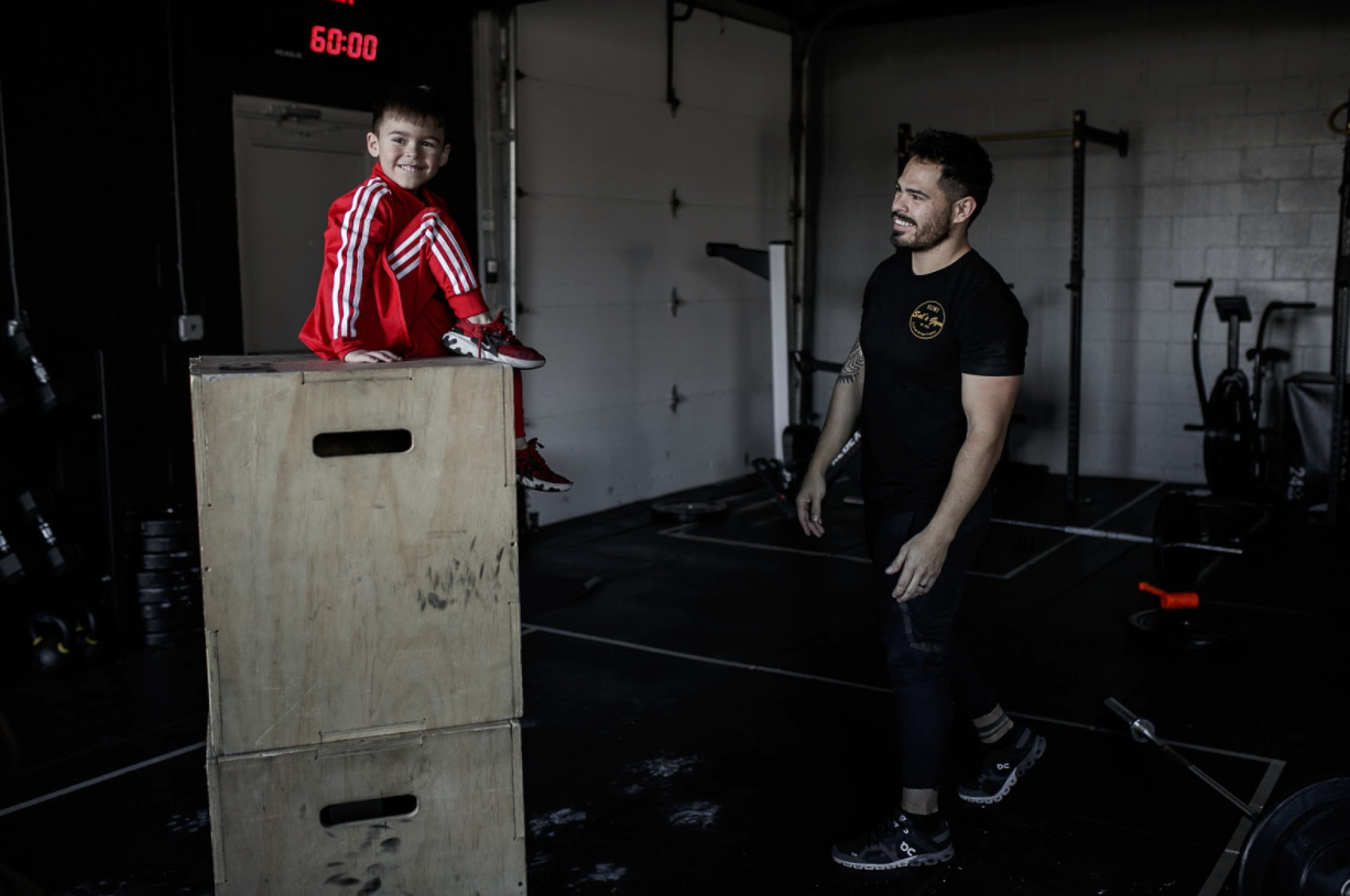 Jake Saldaña and his son play inside of Sal's gym.