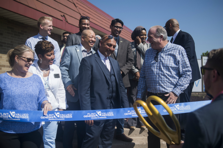 The grand opening of the Sylvester Broome Empowerment Village included a ceremonial ribbon cutting ceremony. 