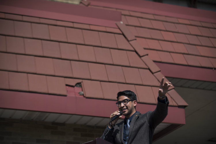 Flint Councilman Santino J. Guerra gives a speech during the ribbon cutting ceremony at the Sylvester Broome Empowerment Village Friday, June 29, 2018 in Flint. 