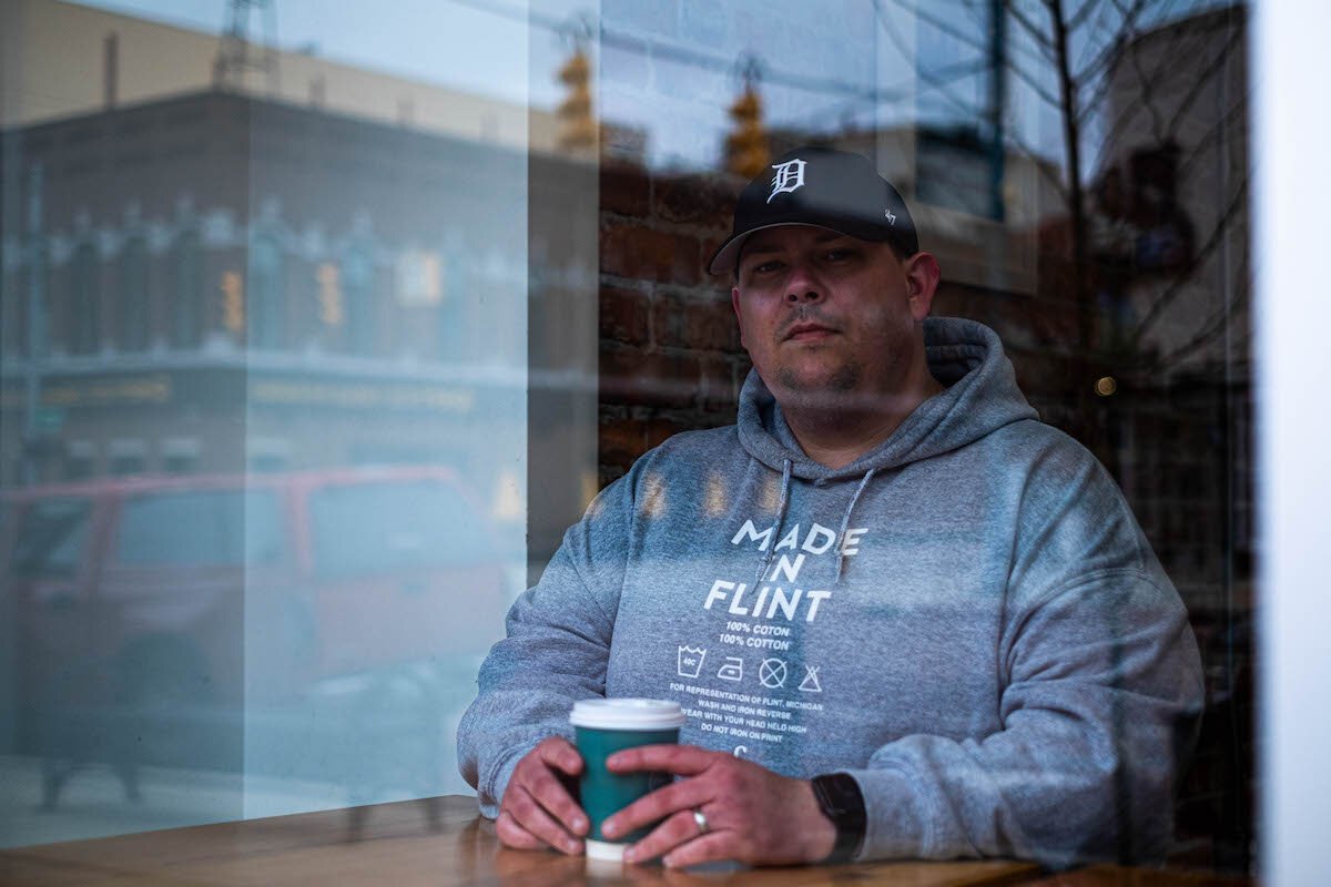 Inside Fosters Coffee in downtown Flint, on a cold, cloudy Wednesday morning, Flint artist Shemy, dressed in a gray Eight One Zero hoodie, blue jeans, and a black baseball cap, tells me about his life.