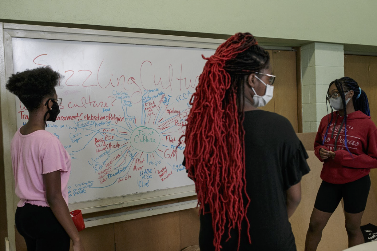 (Pictured left to right) Precious Manns, 14, Ericle Foster, 14, and Charity Manns, 15, discuss what is the definition of culture and what is Flint's culture.