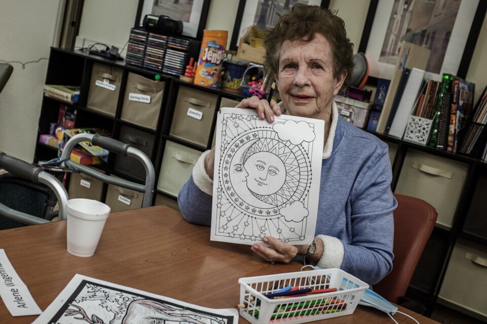 A LifeCircles PACE participant shows off their coloring. LifeCircles provides a day center and encourages participants to attend for socialization. 