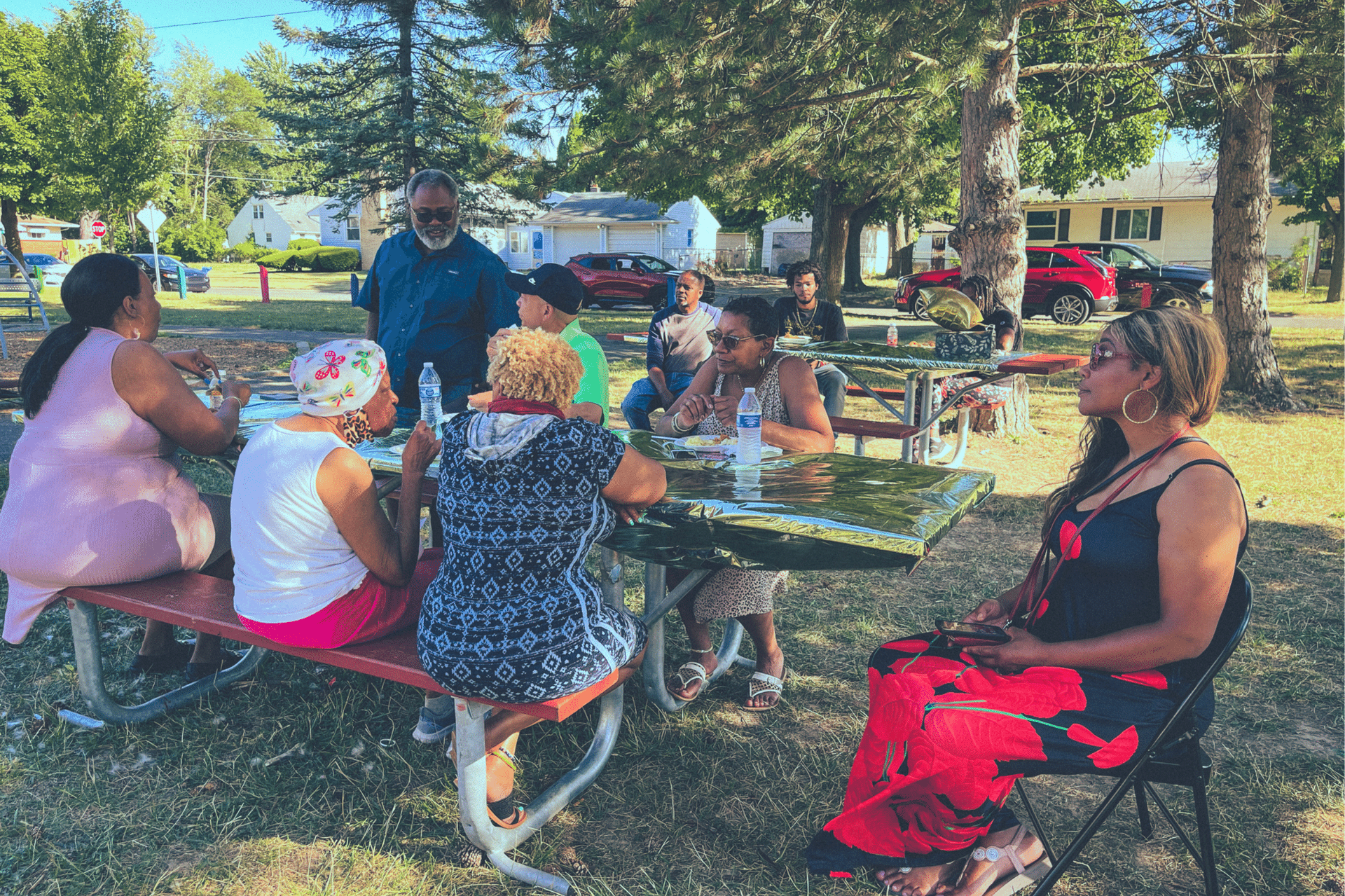 Sarvis Park residents enjoy music, conversations, and food on a hot summer day.