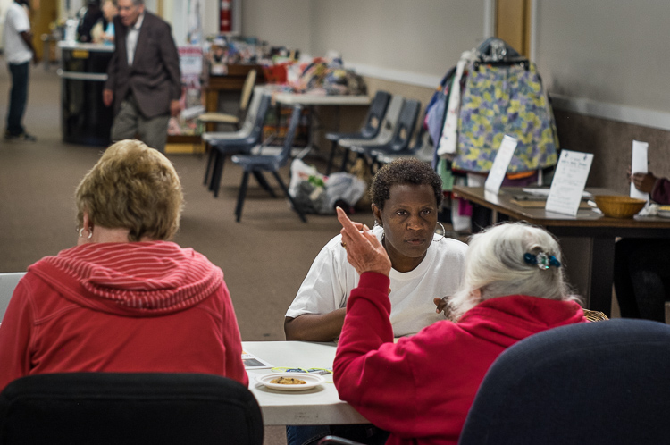 Marie Humphrey of Flint answers questions at an intake screening before receiving a food packet at St. Luke's.