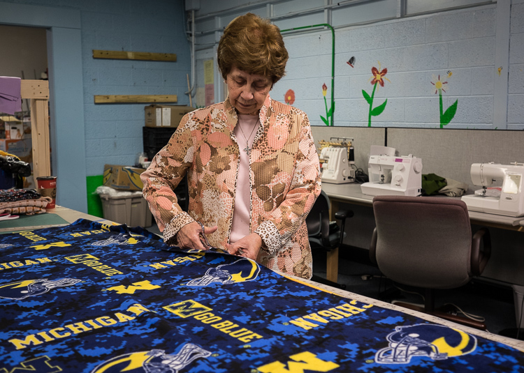 Sister Carol Weber works on a stadium blanket in the sewing center at St. Luke N.E.W. Life Center. She works hands-on as well as her administrative duties.
