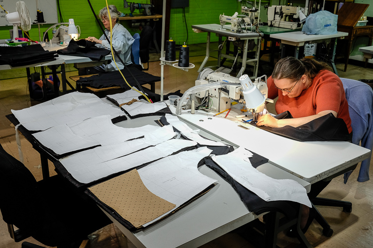 Full-time employee Nicole Zepp assembles a Stormy Kromer vest.  Zepp says she has personally utilized almost every program offered at St. Luke's including New Paths, food pantry, employment prep, and the literacy program. 