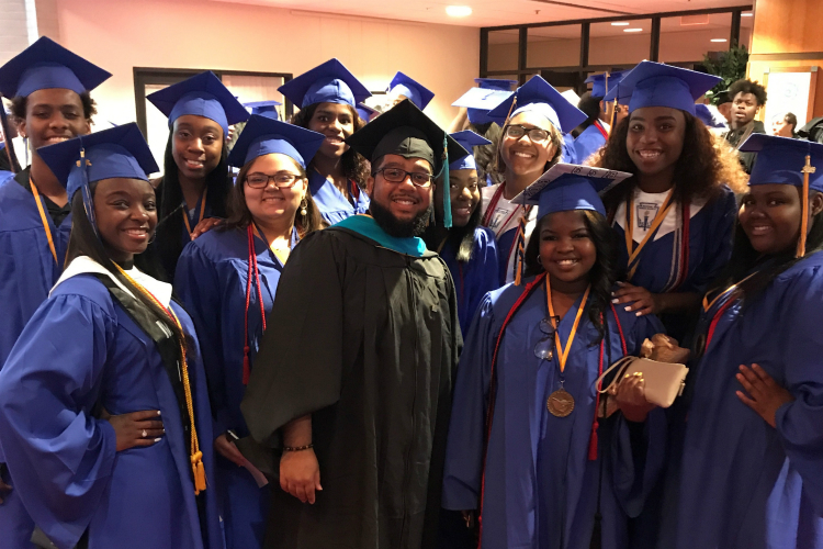 2018 graduates of Flint Southwestern Academy pose for a photo with Community School Director Mohammed Aboutawila after graduation in June.  