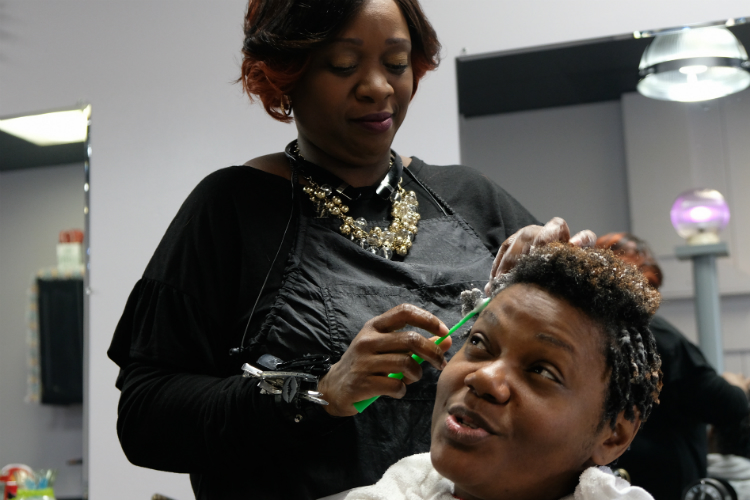 Sweet Tee's serves parents, too. Joyce Sanders brought her daughters to see Theresa Trice-Nelson and gets a set of comb coils herself.