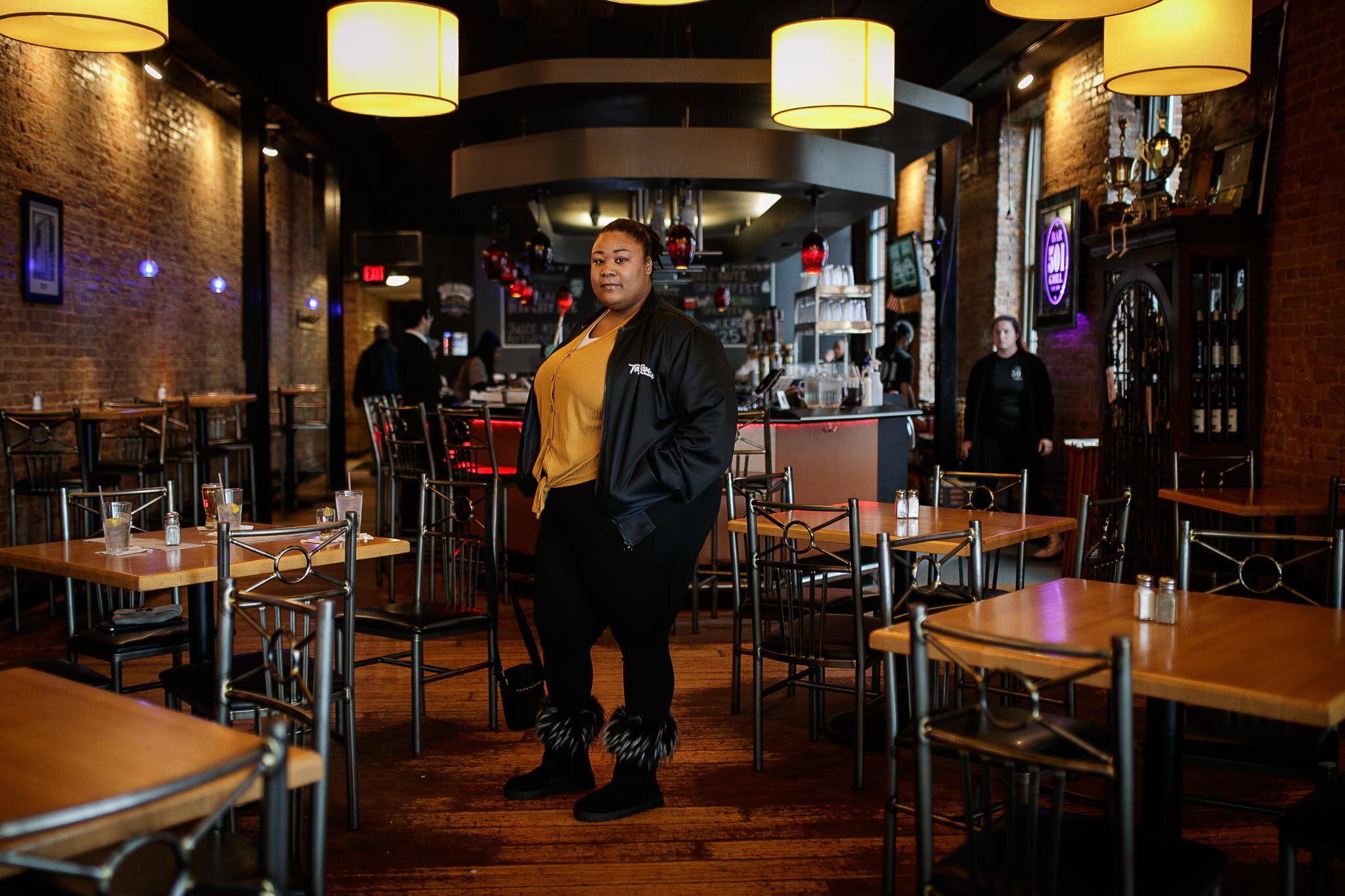 Music artist Tay Boogie stands confidently inside 501 Bar & Grill of downtown Flint.