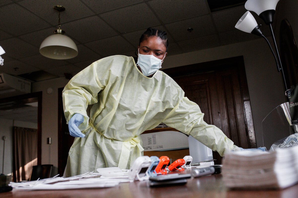 Faye Rankin, a Honu Labs employee, helps set up testing for residents and employees at Shelter of Flint.