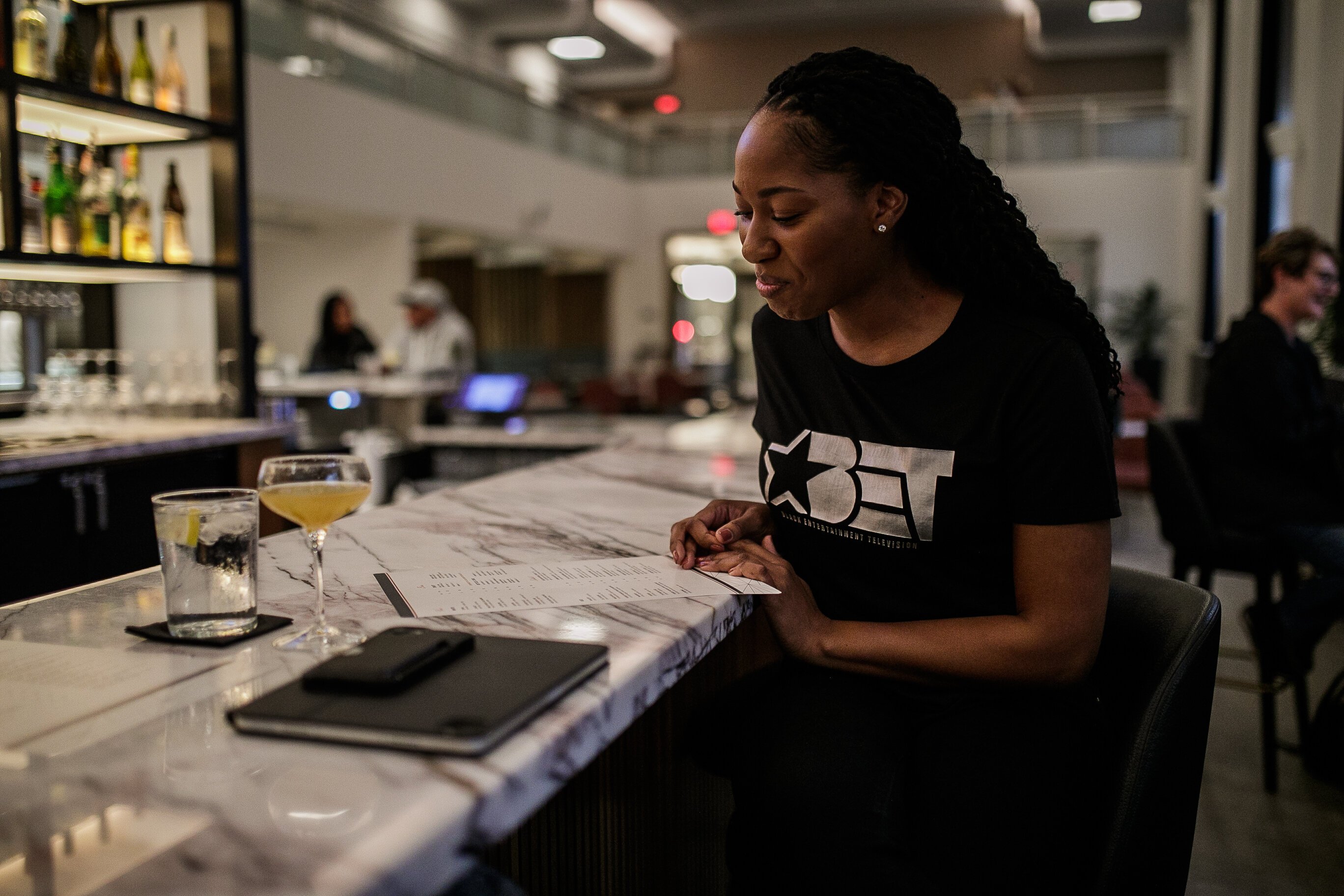 With a nervous smile, the new Managing Editor looks over the drink menu at Sauce Italian American Kitchen located inside Hilton Garden of downtown Flint.