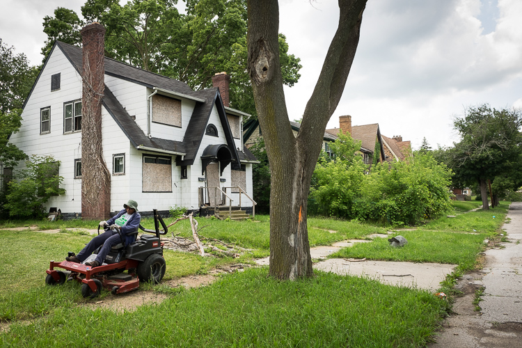 Jean Harrison mows on Grace Street using equipment from the Community Tool Shed.