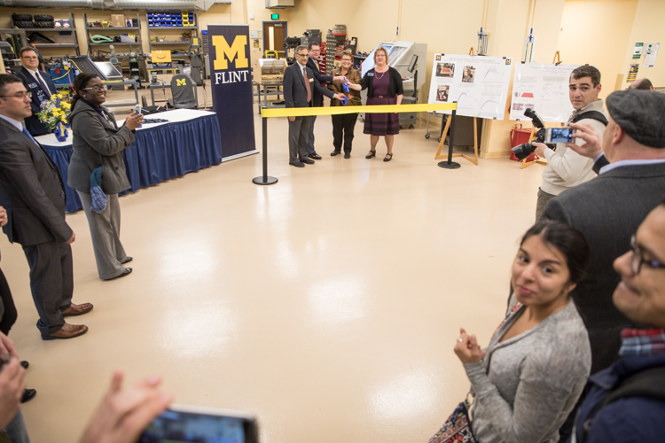 Preparing to cut the ribbon at UM-Flint's Engineering Design Studio & Learning Space.